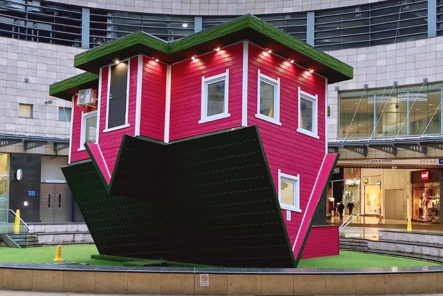 A bright pink upside down house 